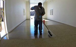 man working on epoxy garage floor coatings in goodyear garage