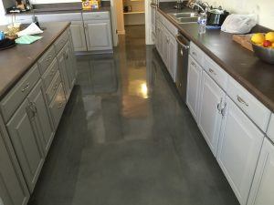 Picture of a recent concrete kitchen floor stained by Barefoot Surfaces
